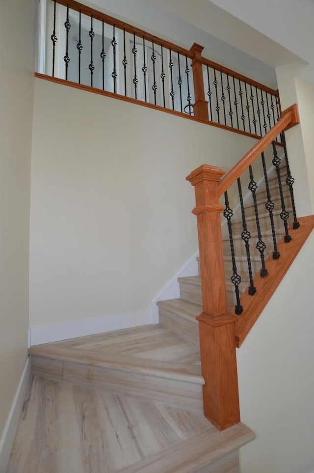 staircase with parquet flooring and baseboards