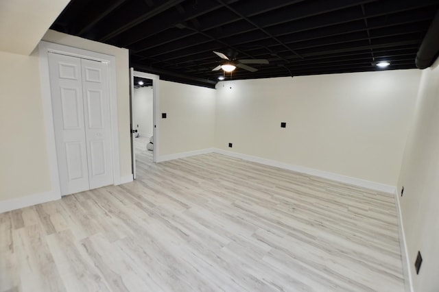 finished basement with light wood-style flooring and baseboards