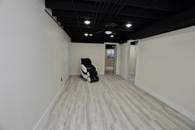 unfurnished room featuring baseboards, wood finished floors, and a ceiling fan