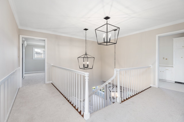 hall with light colored carpet, crown molding, and an inviting chandelier