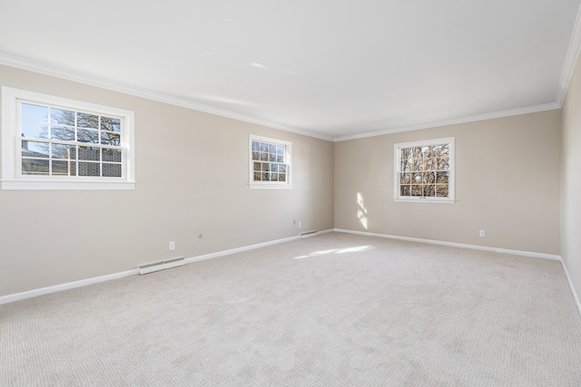 carpeted spare room featuring plenty of natural light, crown molding, and a baseboard radiator