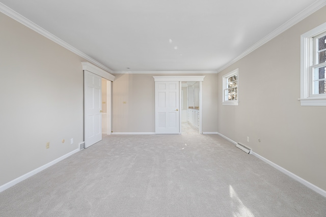 unfurnished bedroom with light colored carpet and crown molding