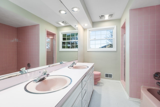 bathroom featuring tile patterned flooring, vanity, and toilet