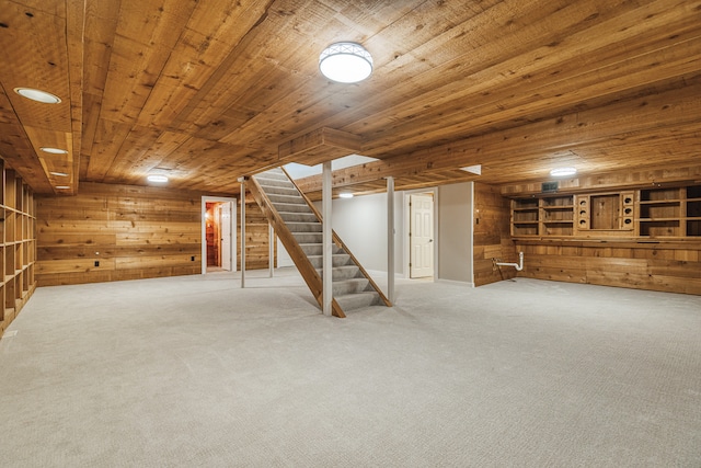 basement featuring carpet flooring, wooden walls, and wood ceiling