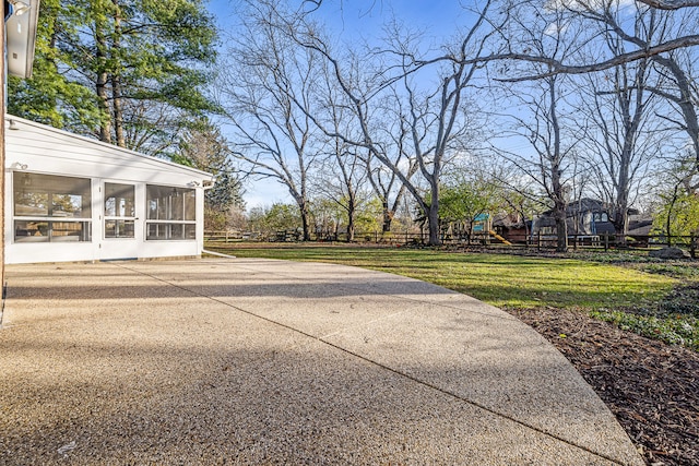 view of patio / terrace with a sunroom and a playground