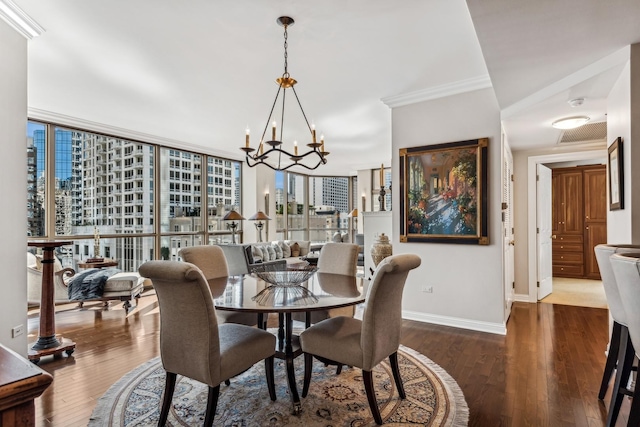 dining space with dark hardwood / wood-style floors, expansive windows, crown molding, and a notable chandelier