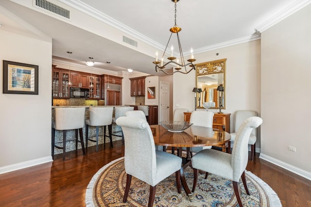 dining room featuring crown molding, a chandelier, and dark hardwood / wood-style floors