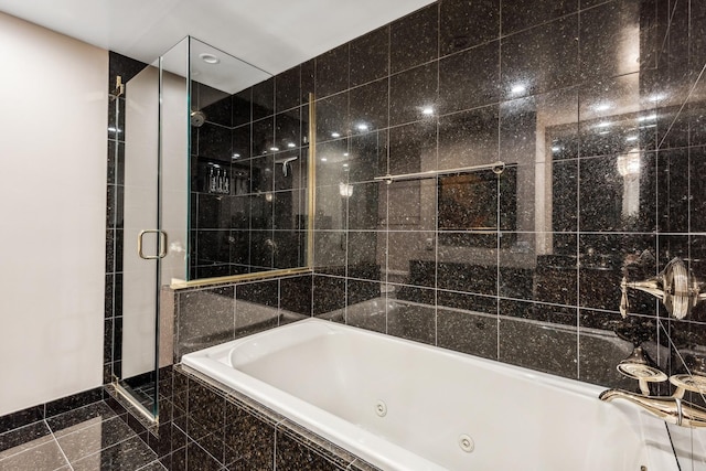 bathroom featuring separate shower and tub and tile walls