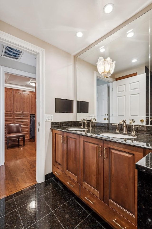 bathroom with vanity and a notable chandelier