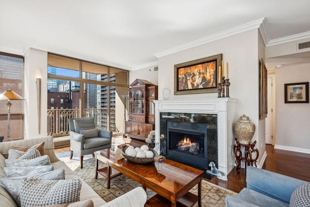 living room with a high end fireplace, light hardwood / wood-style flooring, expansive windows, and crown molding