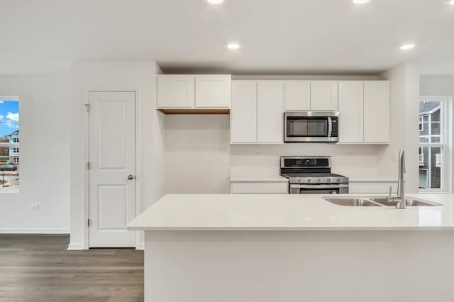 kitchen featuring sink, white cabinets, dark wood-type flooring, and appliances with stainless steel finishes