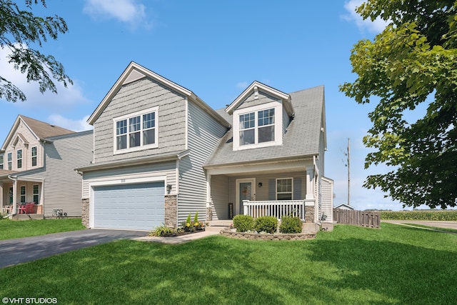 view of front facade featuring a front yard, a porch, and a garage