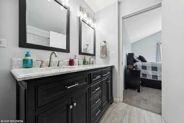 bathroom with vanity and lofted ceiling