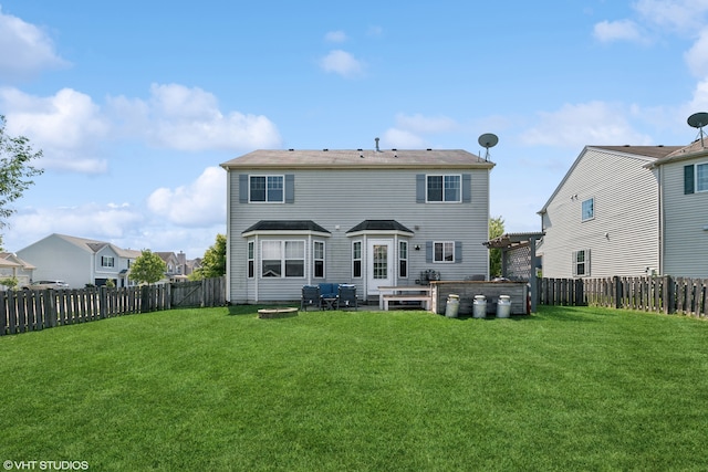 back of house featuring a pergola and a yard