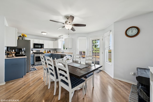 dining area with light hardwood / wood-style floors and ceiling fan