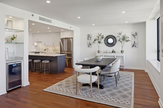 dining room featuring wine cooler, dark wood finished floors, visible vents, and recessed lighting