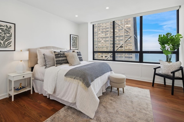 bedroom with wood finished floors and recessed lighting