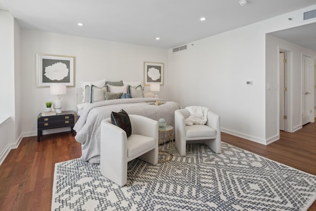 bedroom with baseboards, visible vents, wood finished floors, and recessed lighting