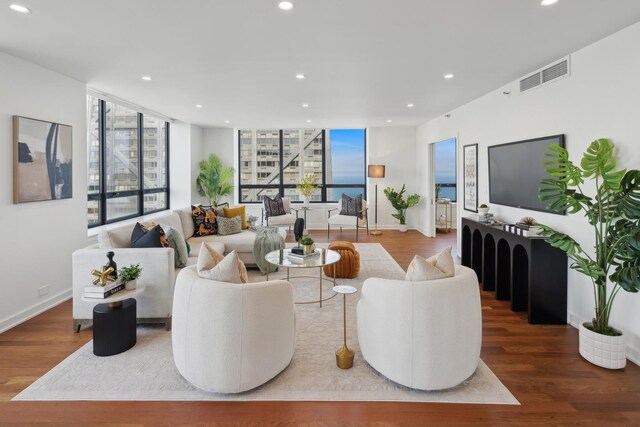180 E Pearson St Unit 5401, Chicago, IL 60611 - living area featuring baseboards, recessed lighting, wood finished floors, and visible vents