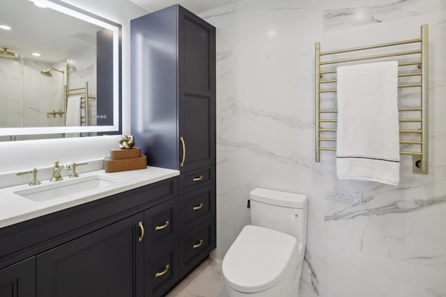 bathroom with marble finish floor, radiator heating unit, vanity, and toilet