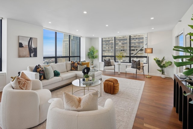 living room featuring recessed lighting, baseboards, and wood finished floors