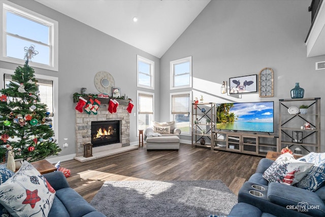 living room with plenty of natural light, high vaulted ceiling, and dark hardwood / wood-style floors