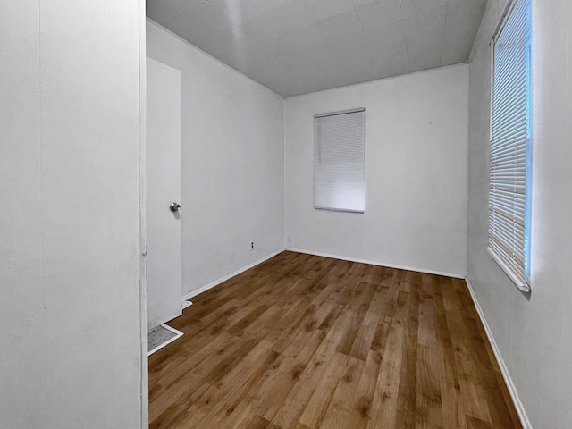 unfurnished room with hardwood / wood-style floors