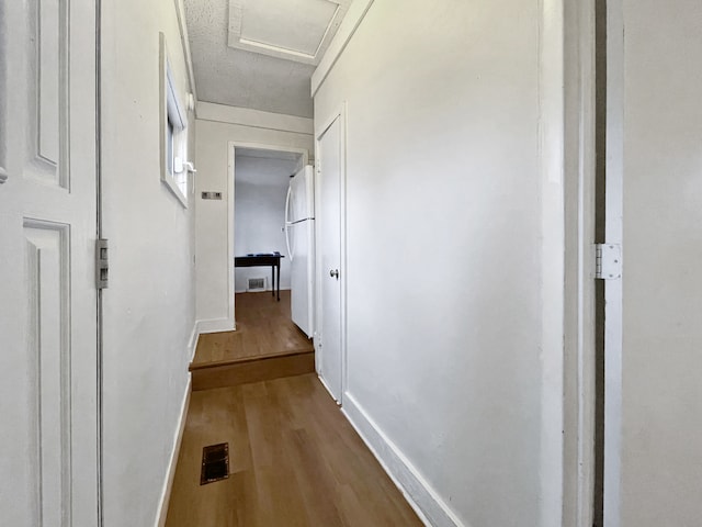 corridor featuring wood-type flooring