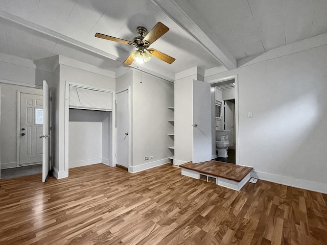 unfurnished living room featuring beam ceiling, ceiling fan, and hardwood / wood-style floors