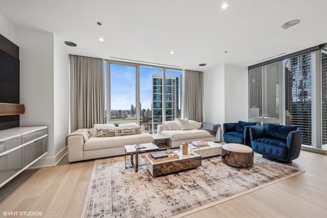 living room with floor to ceiling windows and light wood-type flooring