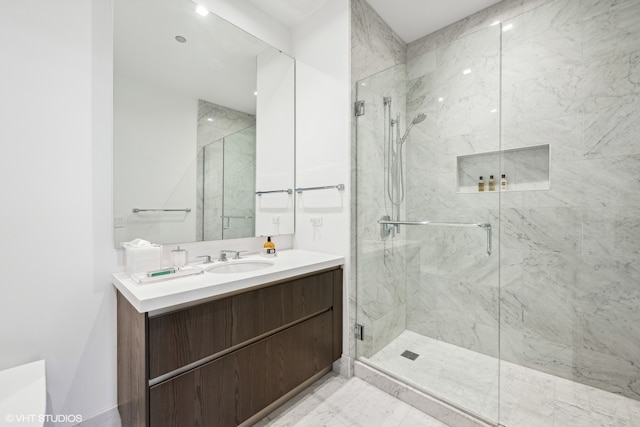 bathroom with a shower with door and vanity