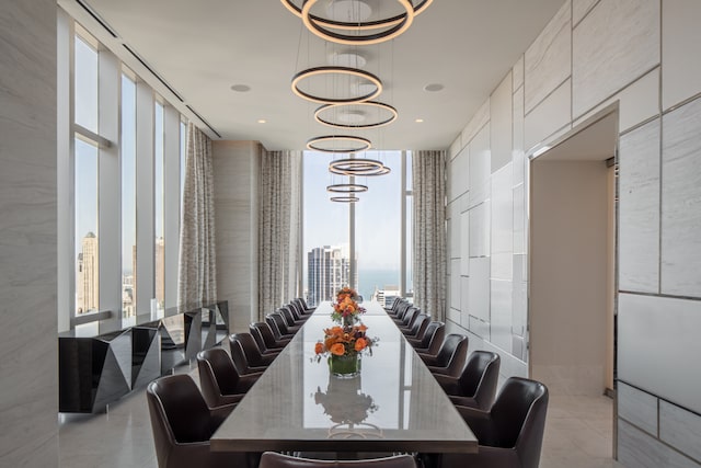 dining space with floor to ceiling windows and a chandelier