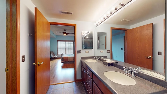 full bathroom with double vanity, tile patterned flooring, a sink, and visible vents