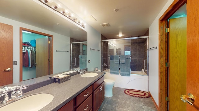 bathroom featuring a sink, toilet, and double vanity