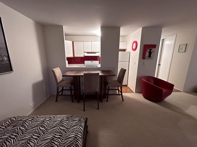 dining area with light colored carpet