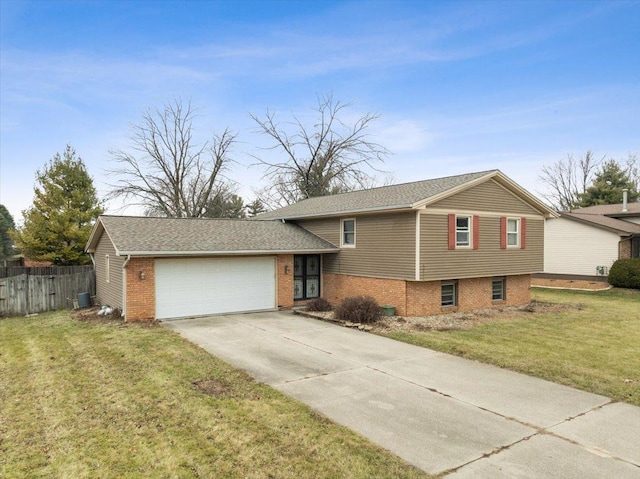 split level home featuring a garage and a front lawn