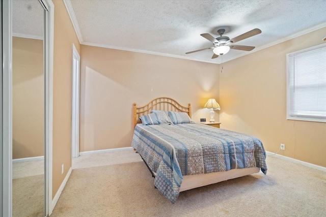 carpeted bedroom with multiple windows, ceiling fan, a textured ceiling, and ornamental molding