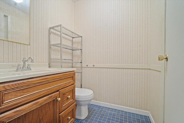 bathroom with tile patterned floors, vanity, and toilet