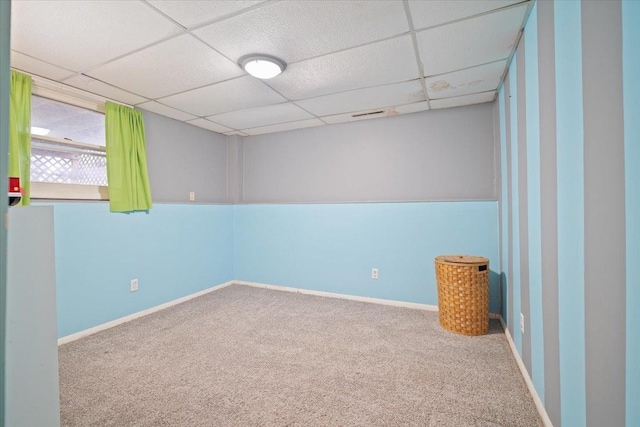 spare room with carpet flooring and a paneled ceiling