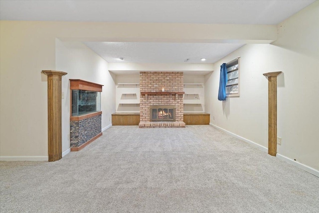 unfurnished living room featuring carpet flooring, a fireplace, and built in features