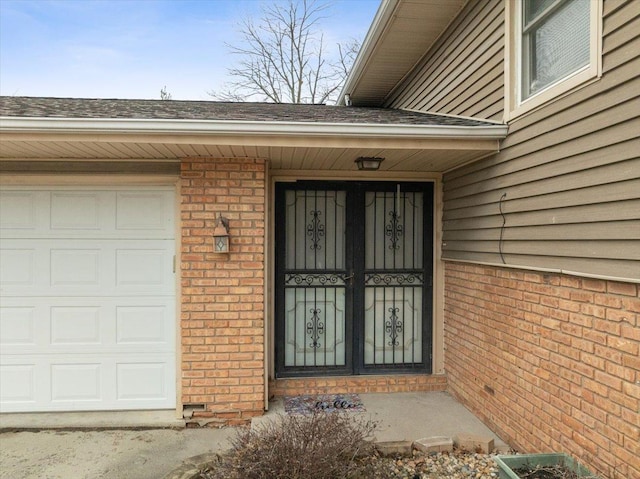 view of exterior entry featuring french doors and a garage