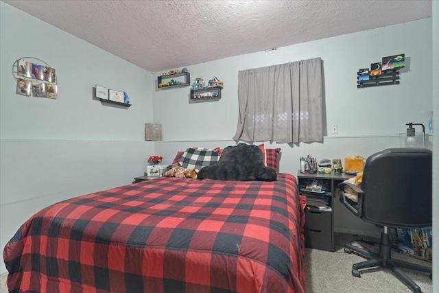 bedroom featuring carpet and a textured ceiling