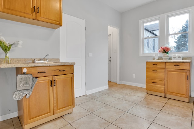 kitchen featuring light tile patterned floors and sink