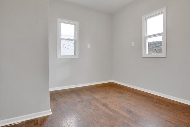 empty room with dark wood-type flooring