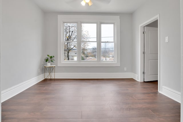 unfurnished room with ceiling fan and dark hardwood / wood-style floors