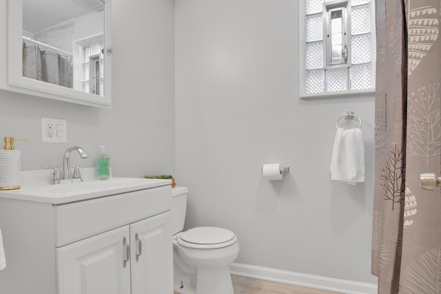 bathroom featuring vanity, a shower with shower curtain, and toilet