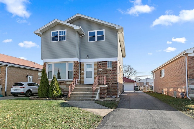 front of property featuring a front yard, an outdoor structure, and a garage