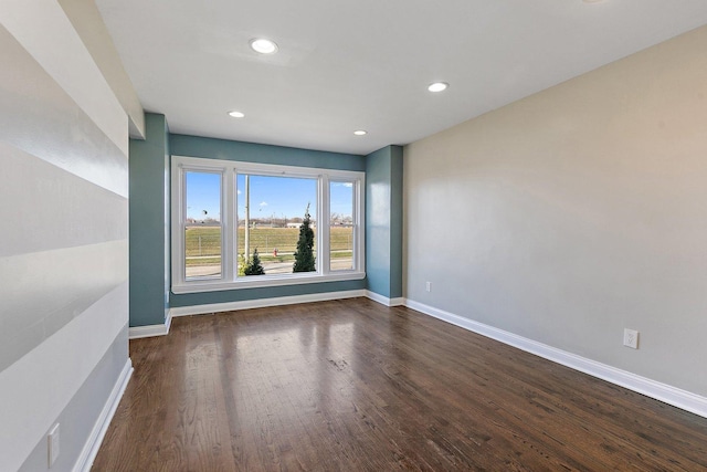 empty room with dark hardwood / wood-style floors