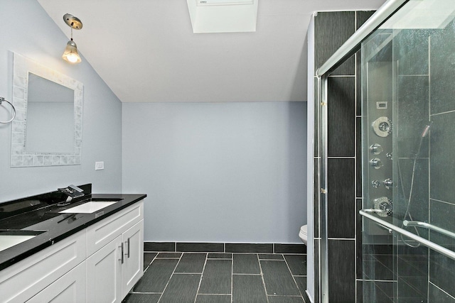 bathroom with an enclosed shower, vanity, toilet, and vaulted ceiling