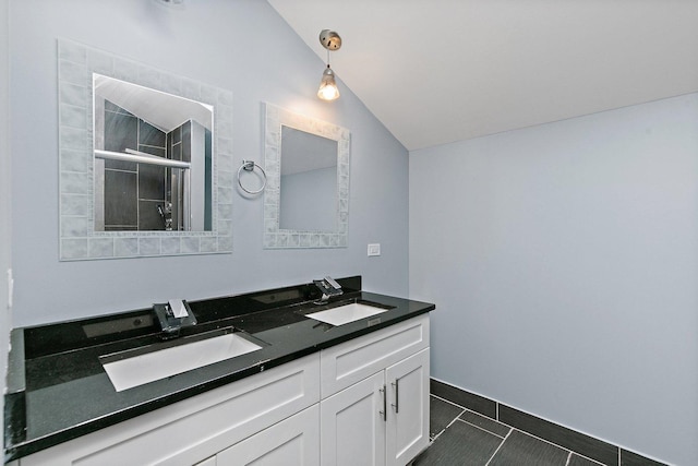 bathroom featuring tile patterned flooring, vanity, a shower with shower door, and vaulted ceiling